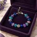 Blue and purple murano glass Pandora-style bracelet with pink crystal centerpiece