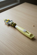 Yellow Bee-Yotch beaded box cutter with buffalo plaid beads and bee charm topper