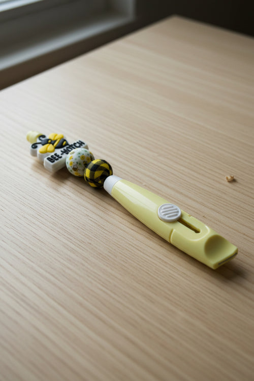 Yellow Bee-Yotch beaded box cutter with buffalo plaid beads and bee charm topper