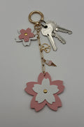Pink and white layered sakura flower charm keychain with gold heart and ice cream cone charm on gold paperclip chain