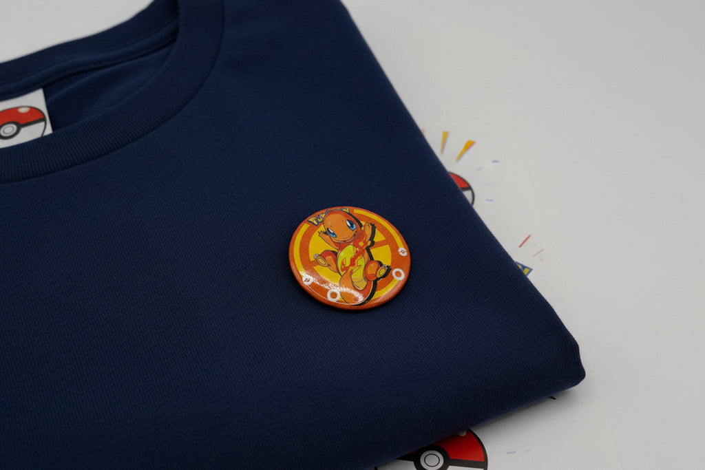 Pokémon Charmander button pin and matching collectible card set on white background