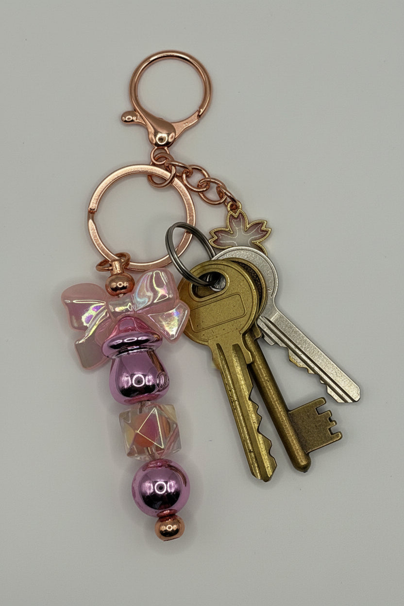 Lavender bow sakura rose gold beaded keychain with metallic purple beads and iridescent cube bead