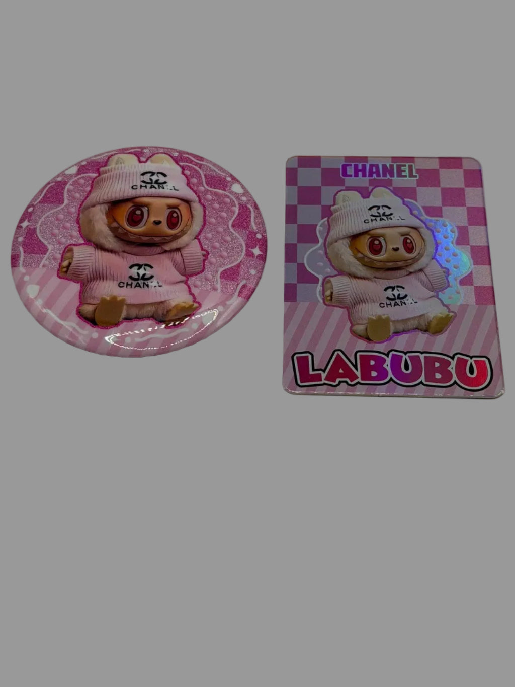 Pink character button pin beside a matching pink checkerboard collectible card