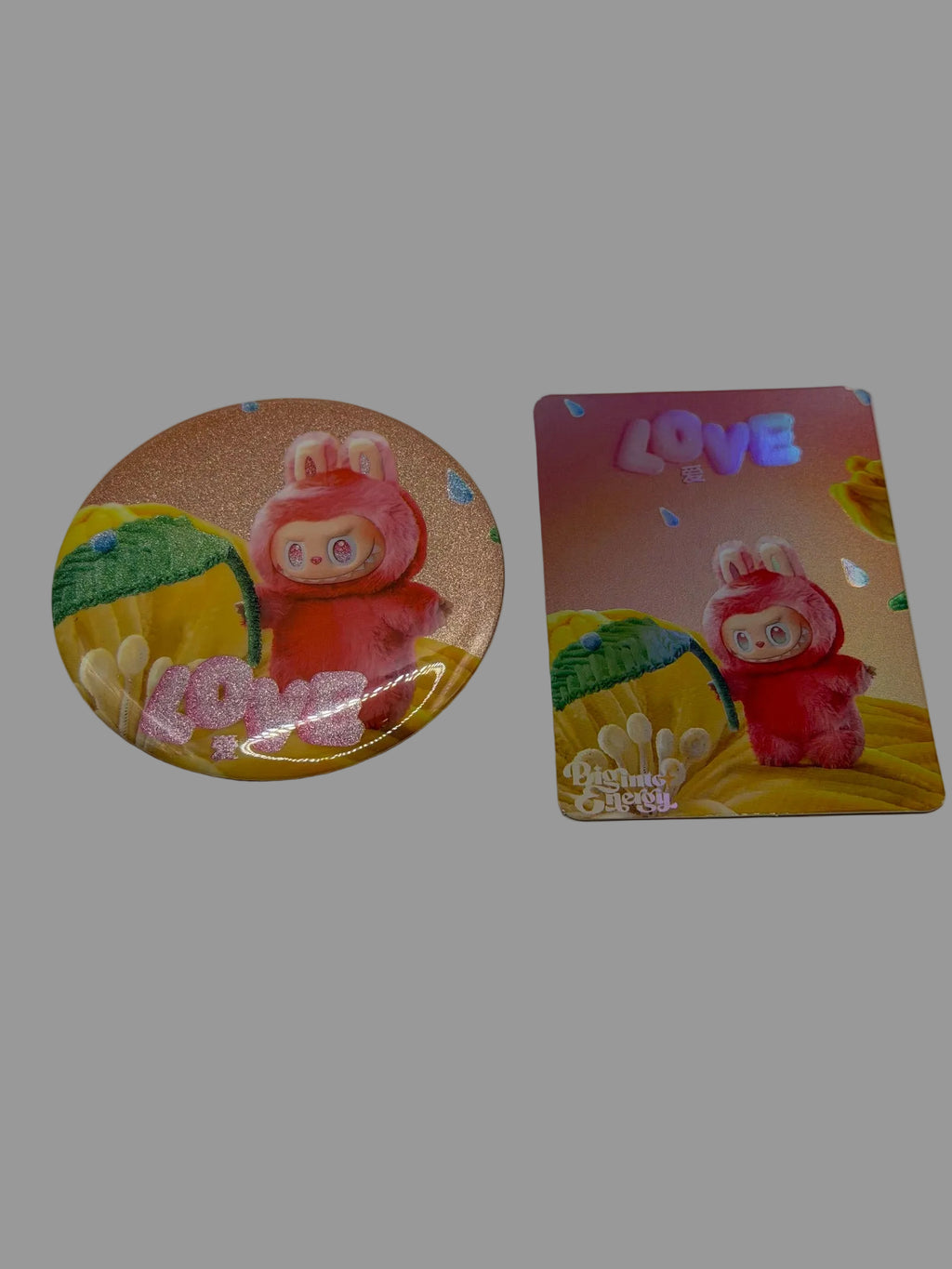 Pink and red Love character button pin beside its matching collectible card