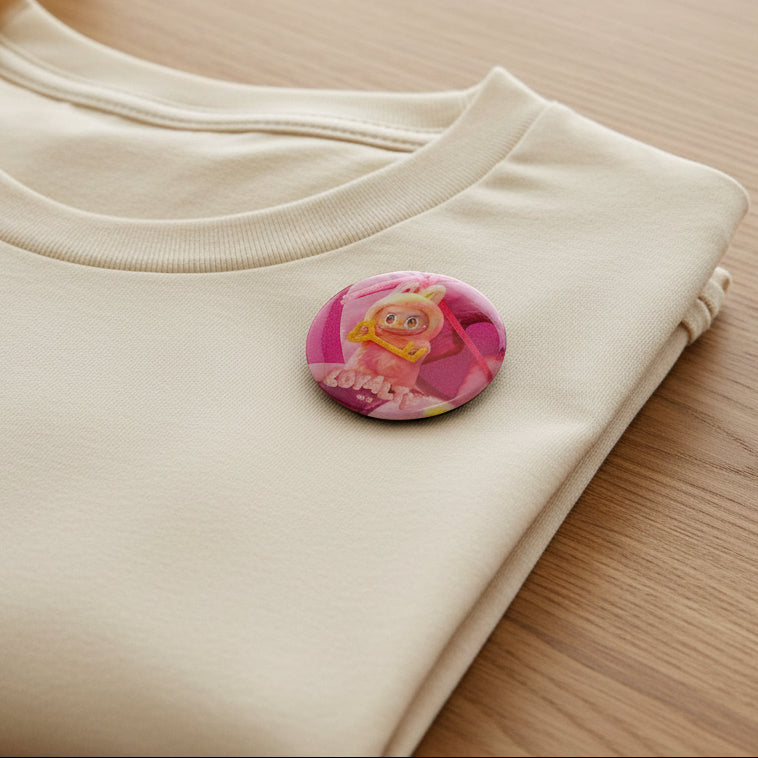 Pink Loyalty character button pin beside its matching collectible card