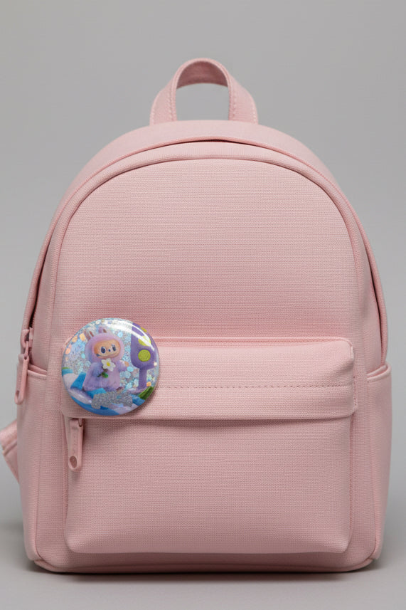 Purple and blue Luck character button pin beside its matching collectible card