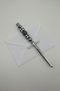 Silver letter opener with black and white buffalo plaid and gray beaded handle