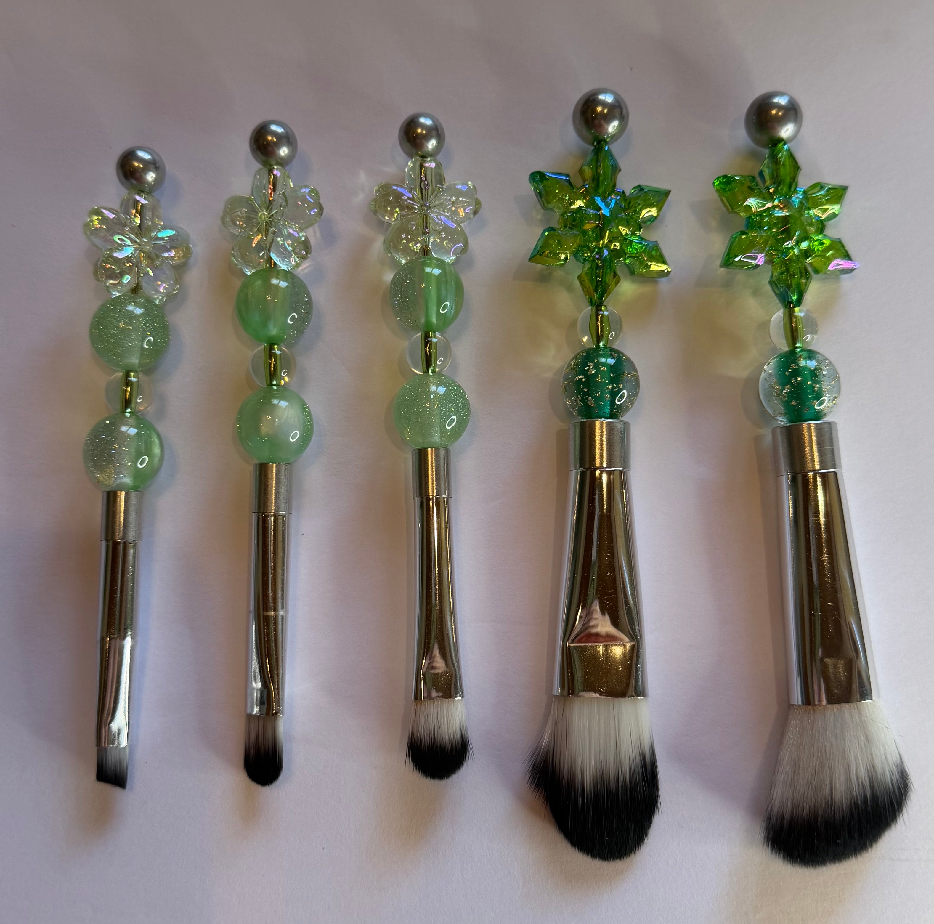 Five green crystal and snowflake beaded makeup brushes with chrome handles