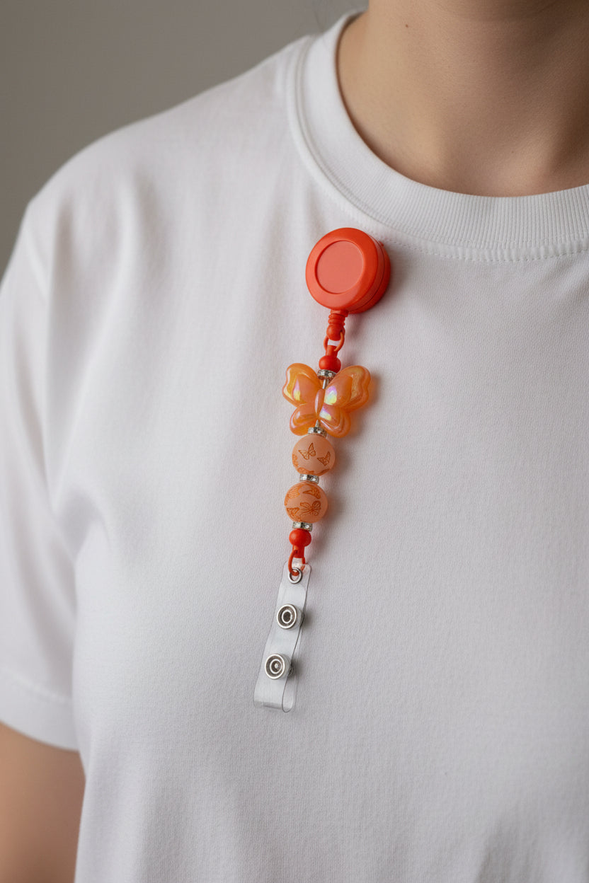 Orange butterfly beaded badge reel lanyard with iridescent butterfly focal bead