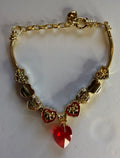 Gold red crystal heart charm bracelet with enamel heart charms and filigree beads on snake chain
