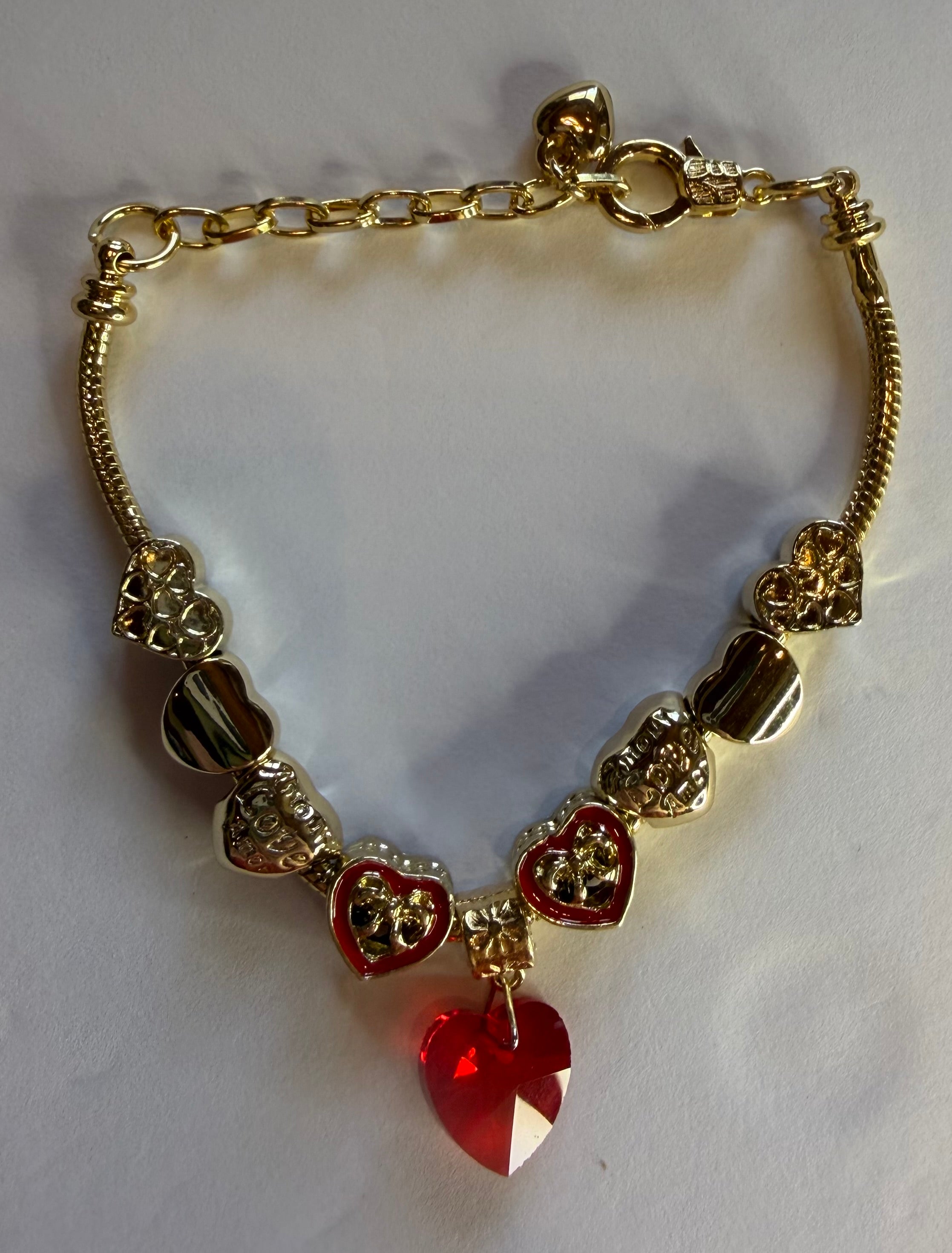 Gold red crystal heart charm bracelet with enamel heart charms and filigree beads on snake chain