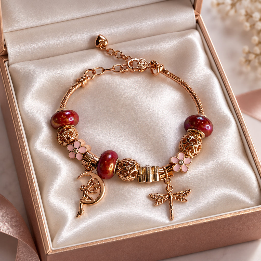 Rose gold fairy and dragonfly charm bracelet with red glass beads and pink flower charm