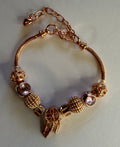 Rose gold dream catcher charm bracelet with feather drops and blush crystal beads