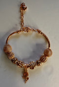 Gold rose charm bracelet with mesh ball beads and dangling rose pendant on snake chain