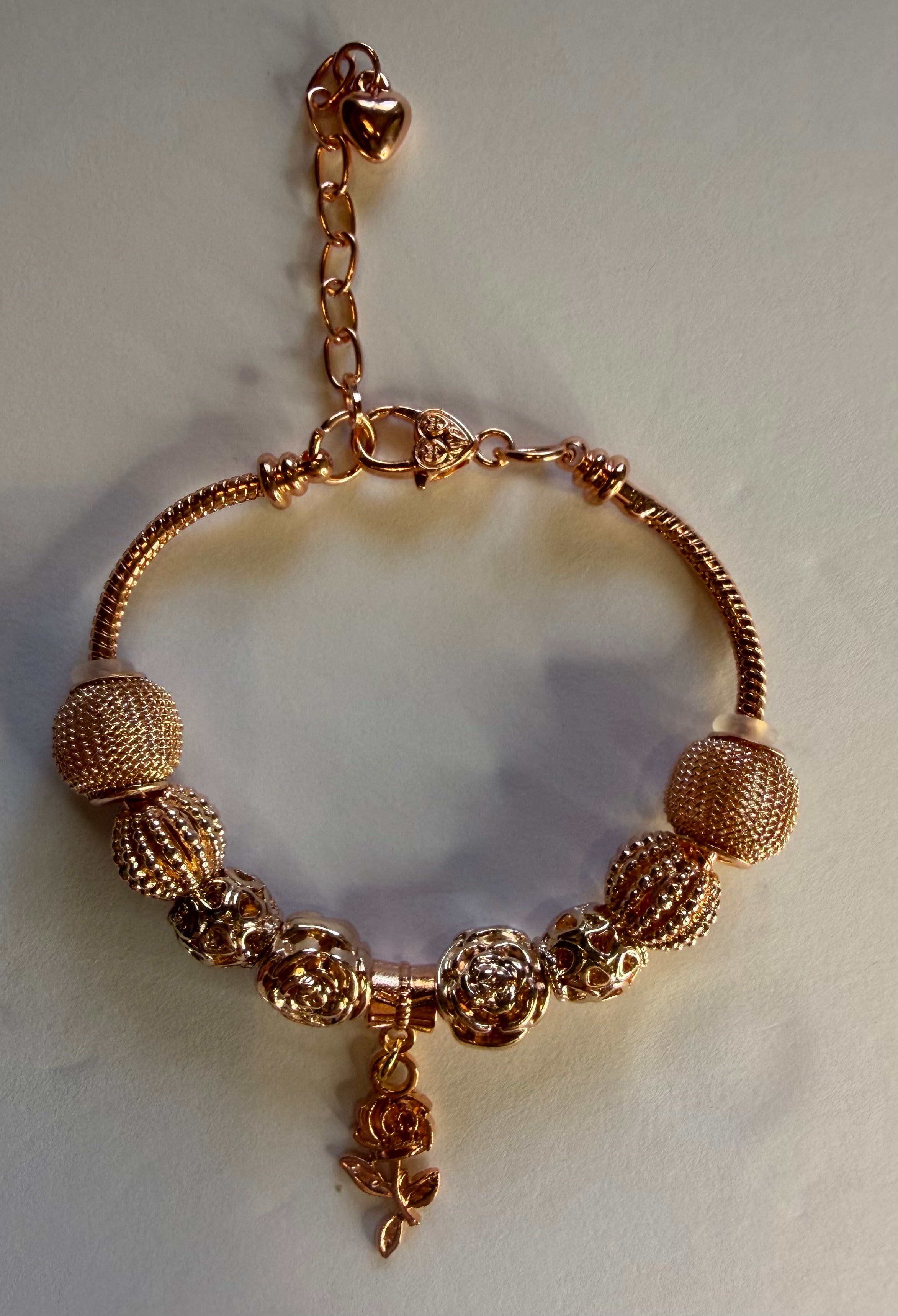 Gold rose charm bracelet with mesh ball beads and dangling rose pendant on snake chain