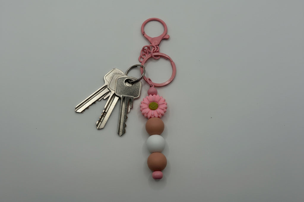 Pink daisy tan and white silicone beaded keychain with matching pink hardware