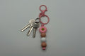Pink daisy tan and white silicone beaded keychain with matching pink hardware