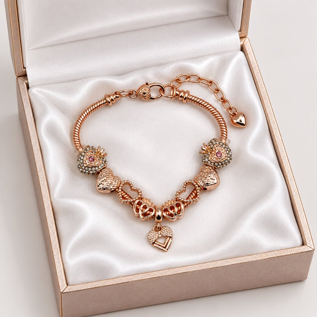 Rose gold snake chain bracelet with crown heart beads, bow charms, and dangling heart pendant