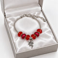 Silver snake chain bracelet with red crystal and matte beads and dangling silver fairy charm