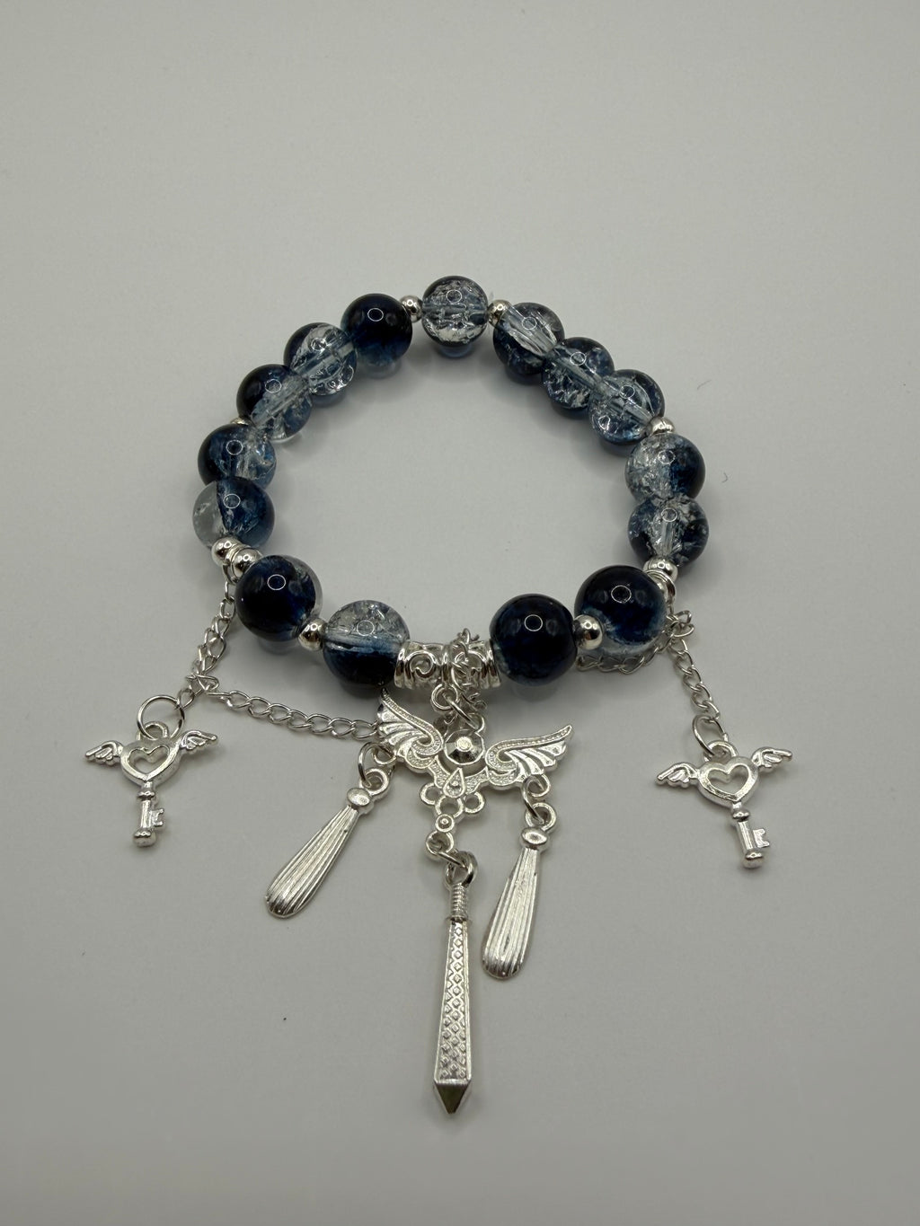 Dark Beaded Stretch Bracelet with Angel Wing & Sword Charms