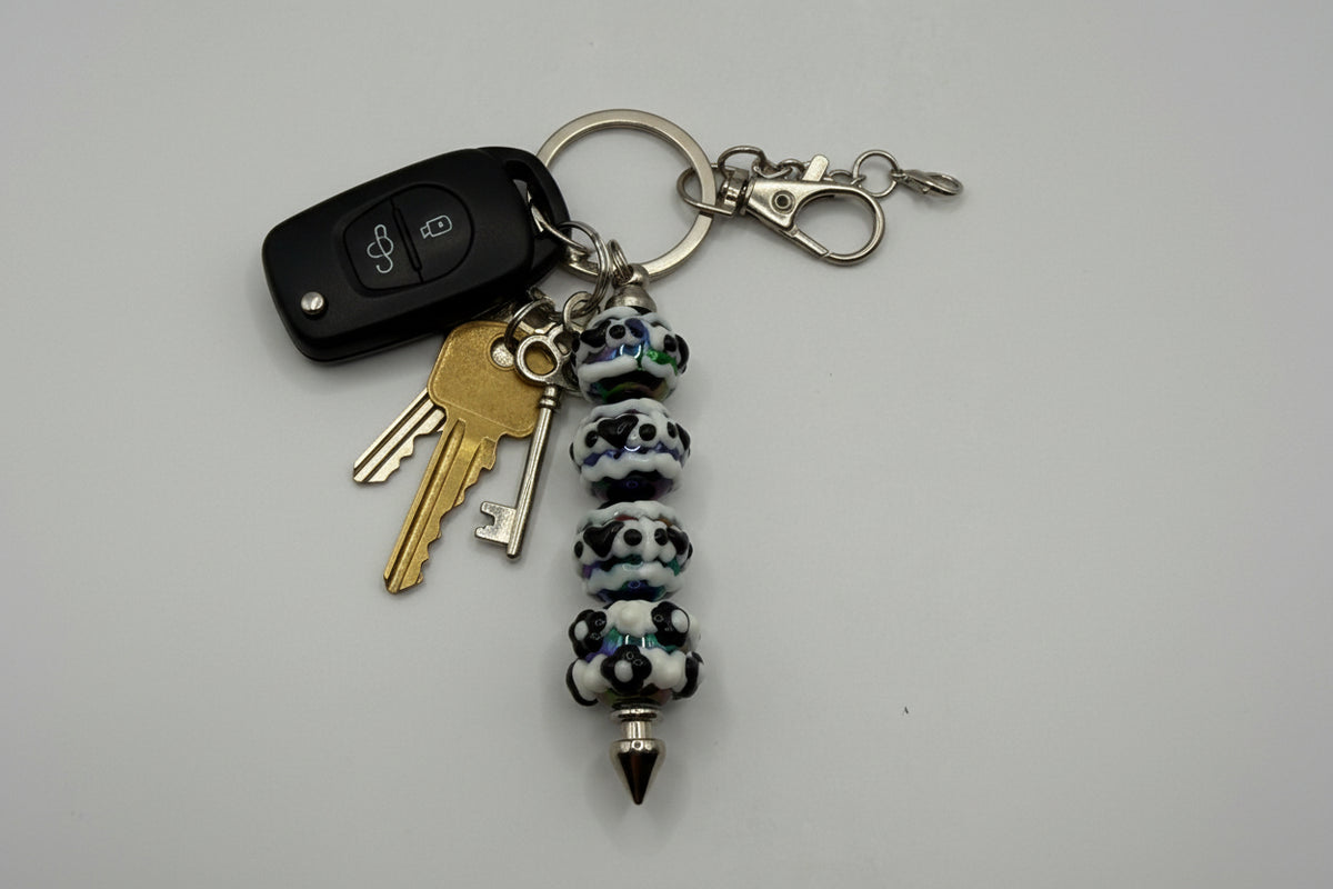 Black and white panda print beaded pen keychain with iridescent shimmer beads and silver spike tip