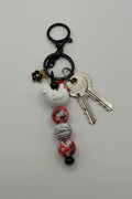 White chicken charm beaded keychain with pink floral beads and black hardware