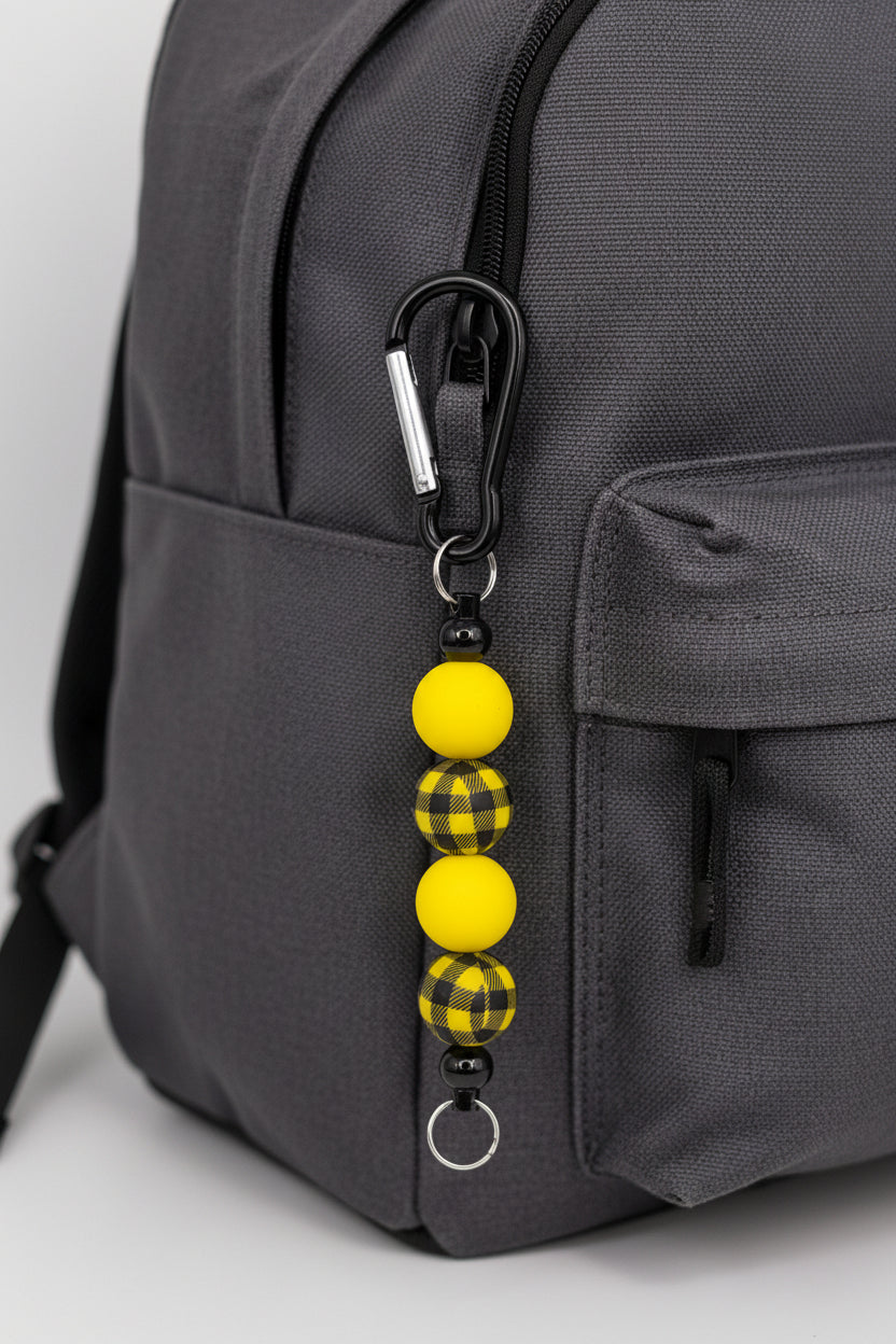 Yellow and black buffalo plaid beaded keychain with black carabiner clip