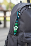 Green paw print beaded keychain with metallic blue accent beads and blue carabiner