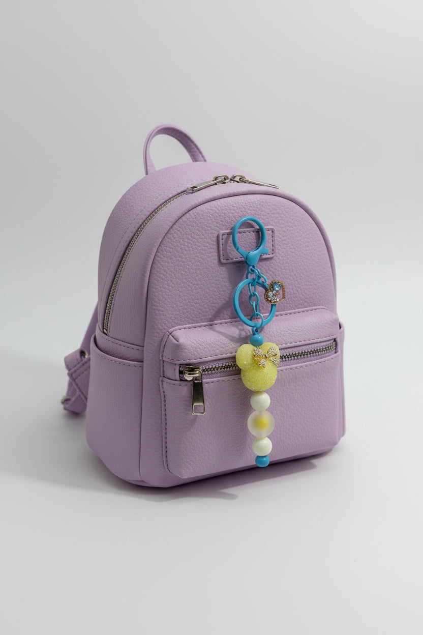 Yellow glitter Mickey bow beaded keychain with cream and blue silicone beads and gold crystal heart charm on blue hardware