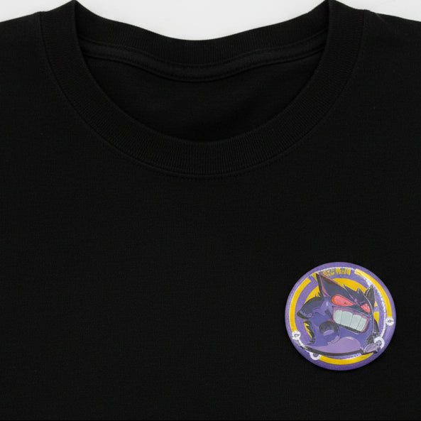 Pokémon Gengar button pin and matching collectible card set on white background