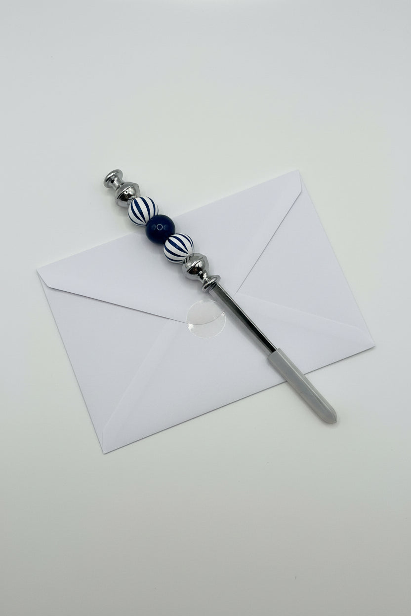 Navy and white striped beaded letter opener with solid navy accent bead