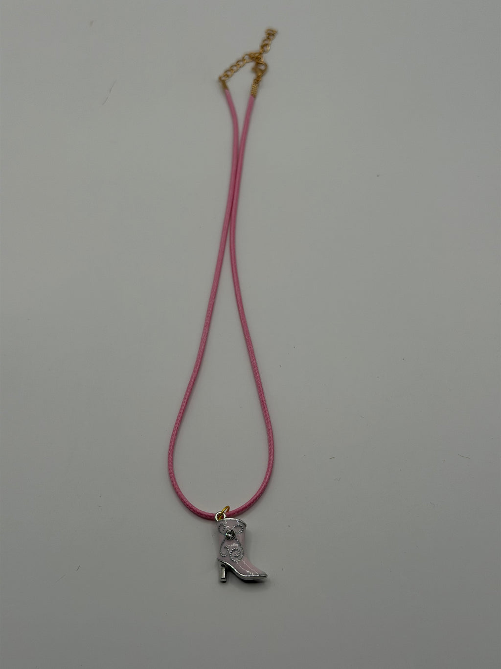 Handmade pink cord necklace with silver rhinestone cowboy boot charm and gold adjustable extender chain