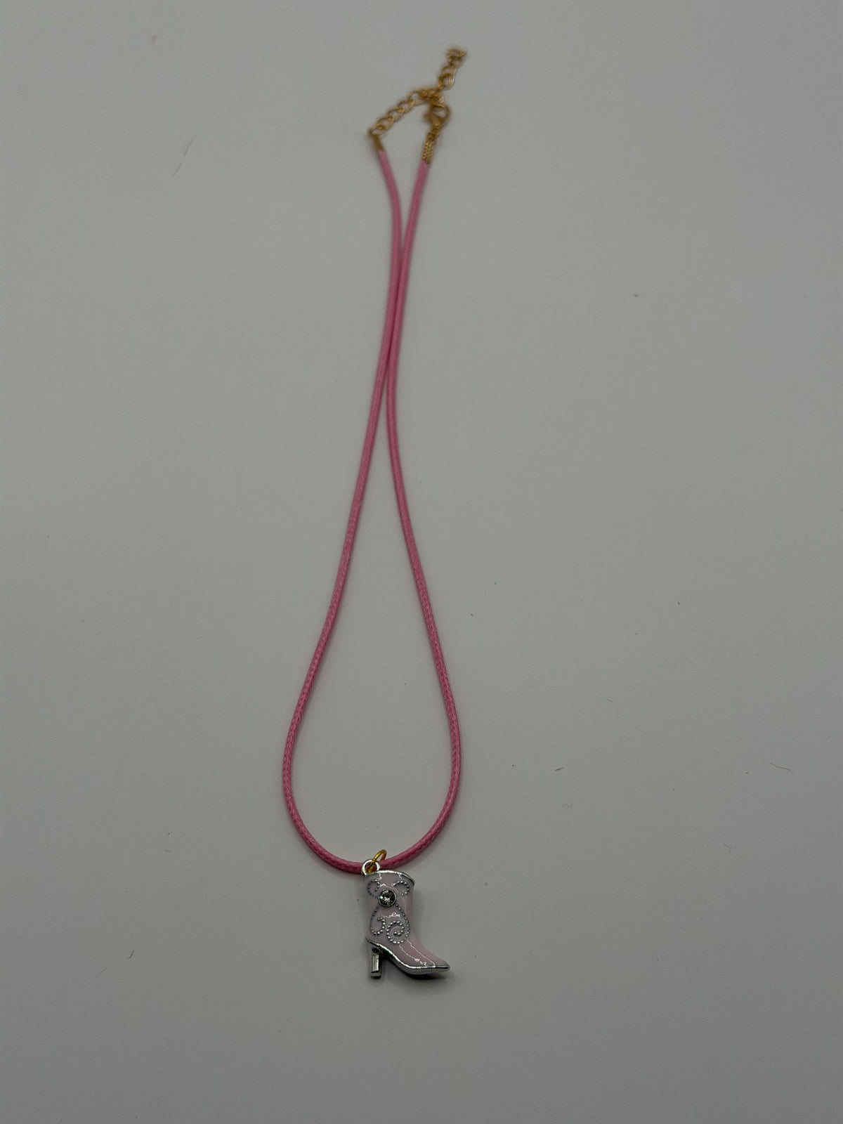 Handmade pink cord necklace with silver rhinestone cowboy boot charm and gold adjustable extender chain