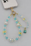 Aqua blue crystal and clear bear bead phone wristlet with cream flower beads and silver ocean charm