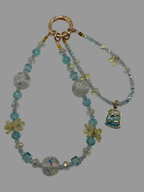 Aqua blue crystal and clear bear bead phone wristlet with cream flower beads and silver ocean charm