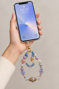 Blue purple and clear double-strand phone wristlet with lavender galaxy beads, blue crystals, flower chips, and gold mushroom charm