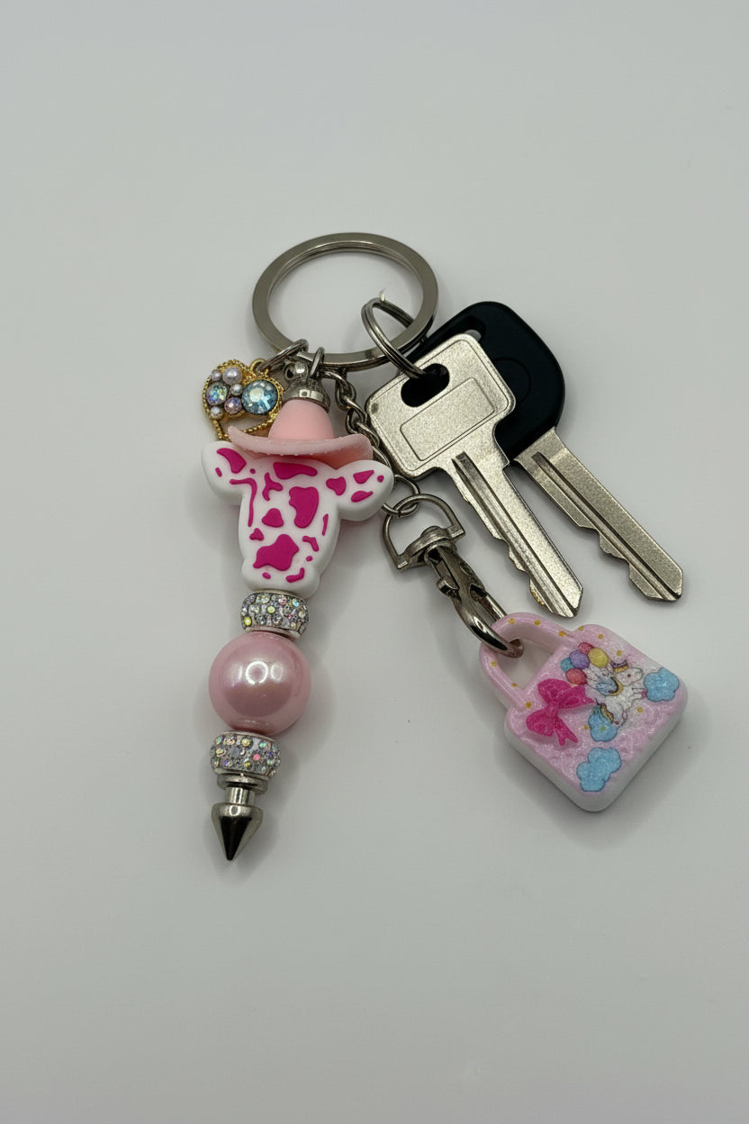 Pink cowboy cow beaded pen keychain with rhinestone spacers, pearl heart charm, and unicorn lock charm