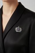 Silver-tone crown brooch with purple cameo and crystal rhinestones on display card