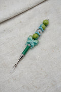 Teal seam ripper with butterfly charm and olive green beaded handle