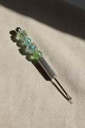 Silver seam ripper with iridescent green crystal and teal beaded handle
