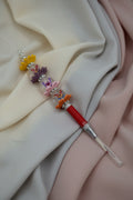 Red seam ripper with butterfly charms and yellow, purple, pink, orange flower beaded handle