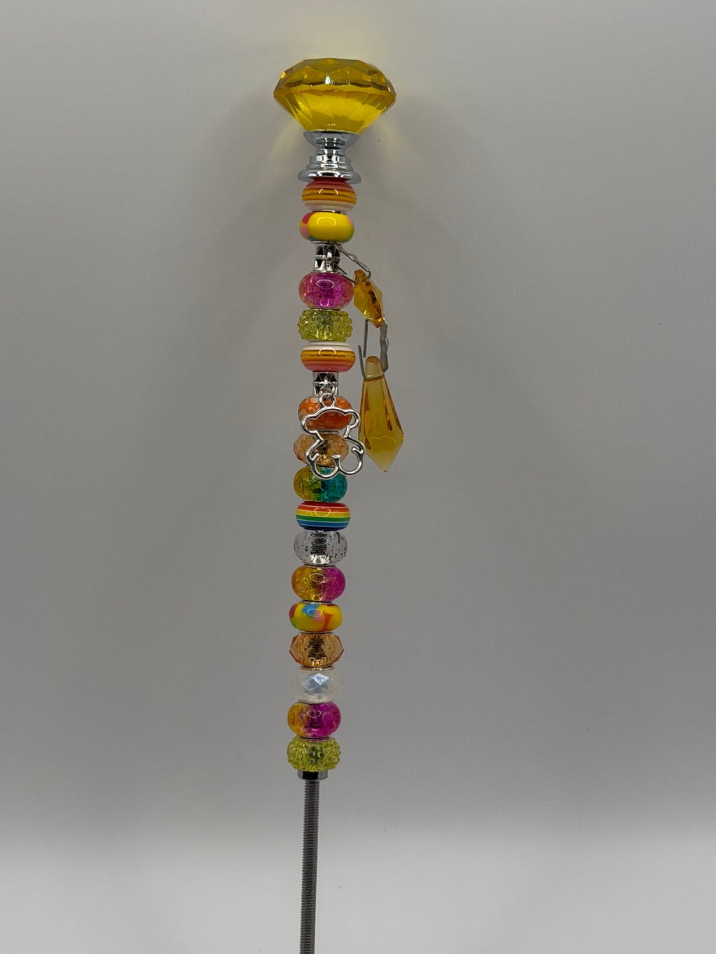 Yellow beaded garden wand stake with yellow dome topper, silver bear charm, and yellow tassel