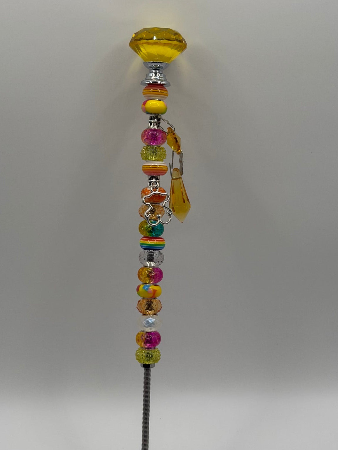 Yellow beaded garden wand stake with yellow dome topper, silver bear charm, and yellow tassel